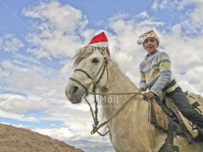 Fair Trade Photo 15-20 years, Activity, Animals, Christmas, Clothing, Clouds, Colour image, Evening, Funny, Hat, Horizontal, Horse, Latin, Looking at camera, Low angle view, One girl, Outdoor, People, Peru, Rural, Sky, Smiling, South America