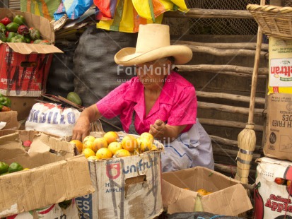 Fair Trade Photo 50-55 years, Activity, Colour image, Day, Entrepreneurship, Food and alimentation, Hat, Horizontal, Latin, Looking away, Market, One woman, Outdoor, Passion fruit, People, Peru, Pink, Portrait fullbody, Selling, Sombrero, South America