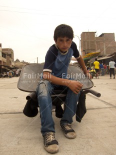 Fair Trade Photo 10-15 years, Activity, Casual clothing, Child labour, Clothing, Colour image, Day, Latin, Looking at camera, Market, One boy, Outdoor, People, Peru, Portrait fullbody, South America, Vertical, Wheelbarrow, Working