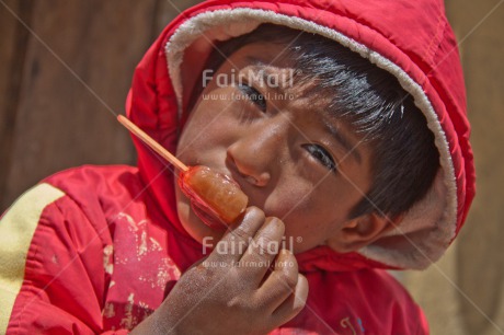 Fair Trade Photo Activity, Colour image, Day, Eating, Food and alimentation, Health, Horizontal, Ice cream, Latin, Looking at camera, Market, One boy, Outdoor, People, Peru, Portrait headshot, Rural, South America