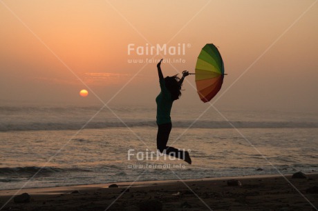 Fair Trade Photo Activity, Beach, Colour image, Evening, Freedom, Horizontal, Jumping, One girl, Outdoor, People, Peru, South America, Sunset, Umbrella