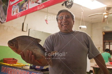 Fair Trade Photo Activity, Animals, Colour image, Entrepreneurship, Fish, Food and alimentation, Horizontal, Looking at camera, Market, One man, People, Peru, Selling, Smiling, South America