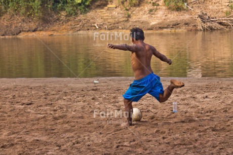 Fair Trade Photo Activity, Ball, Colour image, Day, Health, Horizontal, One boy, Outdoor, People, Peru, Playing, River, Soccer, South America, Sport