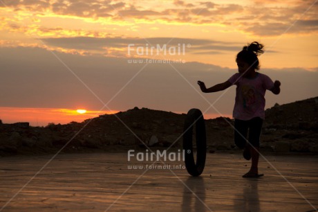 Fair Trade Photo 5 -10 years, Activity, Child, Clouds, Colour image, Evening, Horizontal, Peru, Playing, Shooting style, Silhouette, Sky, South America, Sunset, Wheel