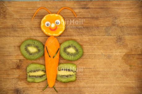 Fair Trade Photo Butterfly, Carrot, Colour image, Creativity, Food and alimentation, Fruits, Horizontal, Kiwi, Orange, Peru, Seasons, South America, Spring, Summer, Table, Wood