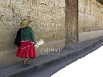 Fair Trade Photo Activity, Clothing, Colour image, Ethnic-folklore, Green, Horizontal, Old age, One woman, Outdoor, People, Peru, Portrait fullbody, Red, Rural, Sombrero, South America, Streetlife, Traditional clothing, Walking, Wool