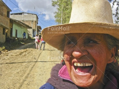 Fair Trade Photo Activity, Colour image, Dailylife, Emotions, Face, Fun, Happiness, Horizontal, Laughing, Looking away, Multi-coloured, Old age, One woman, Outdoor, People, Peru, Portrait headshot, Rural, Smile, Smiling, Sombrero, South America, Streetlife, Teeth