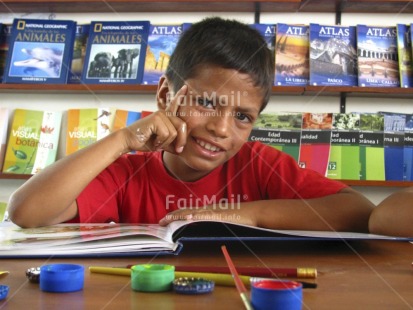 Fair Trade Photo 5-10 years, Activity, Book, Colour image, Day, Education, Exams, Horizontal, Indoor, Latin, Looking at camera, Multi-coloured, One boy, People, Peru, Portrait halfbody, Reading, School, Social issues, South America, Studying