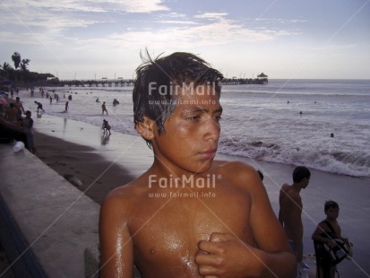 Fair Trade Photo 15-20 years, Activity, Beach, Colour image, Evening, Horizontal, Latin, Looking away, One boy, Outdoor, People, Peru, Portrait halfbody, Seasons, South America, Summer, Water