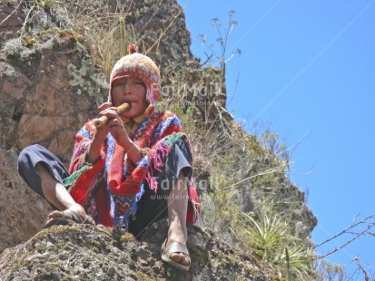 Fair Trade Photo Activity, Clothing, Colour image, Condolence, Ethnic-folklore, Flute, Horizontal, Looking at camera, Multi-coloured, Music, One boy, Outdoor, People, Peru, Poncho, South America, Thinking of you, Traditional clothing, Welcome home