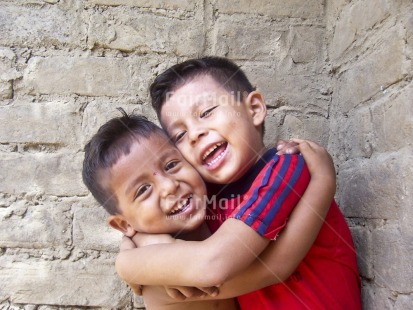 Fair Trade Photo 5-10 years, Activity, Casual clothing, Clothing, Colour image, Day, Family, Friendship, Horizontal, Hug, Hugging, Looking at camera, Love, Multi-coloured, Outdoor, People, Peru, Portrait halfbody, Smile, Smiling, South America, Street, Streetlife, Together, Two boys, Two children