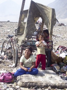 Fair Trade Photo Activity, Animals, Child labour, Colour image, Day, Eating, Environment, Garbage, Garbage belt, Group of children, Health, Hygiene, Outdoor, People, Peru, Pig, Playing, Recycle, Sanitation, Sitting, South America, Vertical