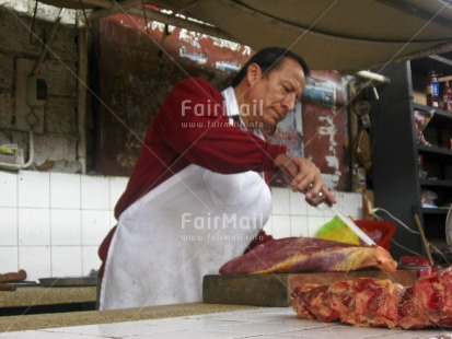 Fair Trade Photo Activity, Casual clothing, Clothing, Colour image, Cutting, Dailylife, Day, Entrepreneurship, Horizontal, Indoor, Looking away, Market, Meat, One man, People, Peru, Portrait halfbody, South America