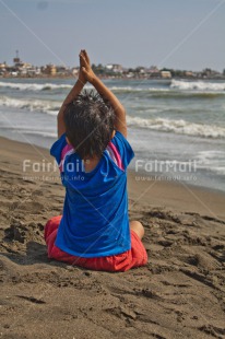 Fair Trade Photo 5 -10 years, Activity, Beach, Casual clothing, Clothing, Colour image, Latin, Looking away, One boy, Outdoor, People, Peru, Sand, Sea, Sitting, South America, Vertical, Yoga