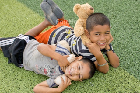 Fair Trade Photo Activity, Animals, Bear, Brother, Child, Colour image, Emotions, Felicidad sencilla, Friend, Friendship, Green, Happiness, Happy, Horizontal, Peru, Play, Playground, Playing, Smiling, South America, Teddybear