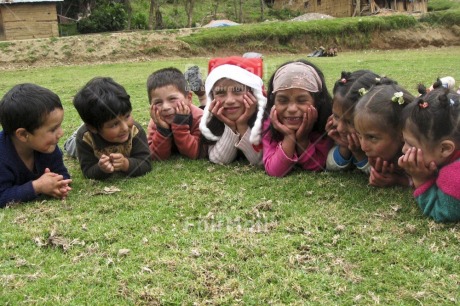 Fair Trade Photo 5 -10 years, Activity, Asian, Casual clothing, Christmas, Clothing, Colour image, Cute, Day, Friendship, Garden, Grass, Group of children, Horizontal, Lying, Outdoor, People, Peru, Smile, Smiling, South America, Together