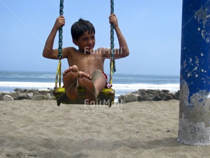 Fair Trade Photo 5 -10 years, Activity, Beach, Colour image, Emotions, Happiness, Horizontal, Latin, Looking away, One boy, People, Peru, Playing, Portrait fullbody, Sea, Seasons, Smiling, South America, Summer