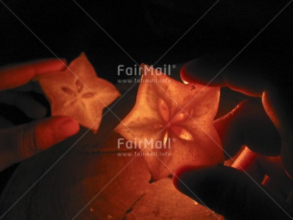 Fair Trade Photo Candle, Christmas, Colour image, Evening, Food and alimentation, Fruits, Hand, Horizontal, Indoor, Peru, South America, Star, Starfruit, Transparent