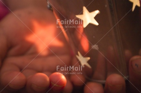 Fair Trade Photo Activity, Candle, Care, Carrying, Christmas, Closeup, Colour image, Evening, Giving, Hand, Horizontal, Indoor, Light, Peru, Pink, Seasons, South America, Star, Warmth, Winter