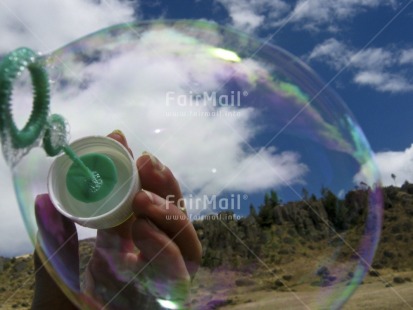 Fair Trade Photo Activity, Closeup, Clouds, Colour image, Growth, Hand, Horizontal, Peru, Playing, Reflection, Rural, Seasons, Sky, Soapbubble, South America, Summer, Transparent