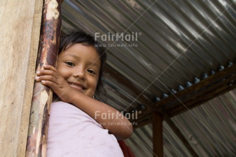 Fair Trade Photo 5 -10 years, Activity, Colour image, Horizontal, House, Latin, Looking at camera, Low angle view, One girl, People, Peru, Portrait halfbody, Smiling, South America