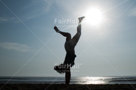 Fair Trade Photo Activity, Beach, Colour image, Doing handstand, Evening, Horizontal, Light, One girl, Outdoor, People, Peru, Sea, South America, Spirituality, Sport, Water, Yoga