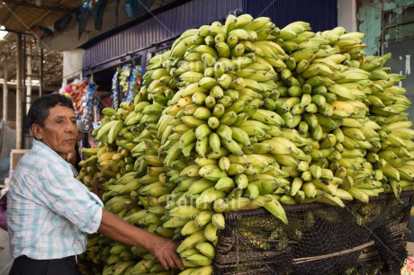 Fair Trade Photo 45-50 years, Banana, Casual clothing, Clothing, Colour image, Day, Entrepreneurship, Food and alimentation, Fruits, Horizontal, Latin, Market, One man, Outdoor, People, Peru, Portrait halfbody, Selling, South America