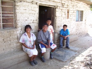 Juan Carlos with his family in front of his parents house