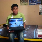 Juan Carlos with his new lap top in his bed room Juan Carlos with his new lap top in his bed room