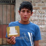 Pasquel with one of his cards in front of his house