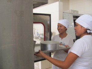 Patricia and Betty putting their cakes in the oven